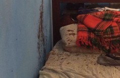 Marcas de sangue sobre a cama e na parede da casa onde vítima foi encontrada morta levantam suspeita de homicídio (Foto: Sidnei Bronka/94FM)